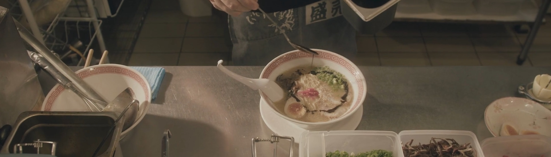 Mesa com uma tigela de Ramen cheio de legumes 